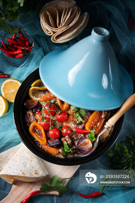 Tasty spicy beef with various vegetables cooked in tagine