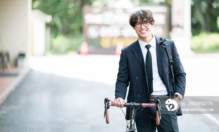 Portrait Of Smiling Male College Student with bike.