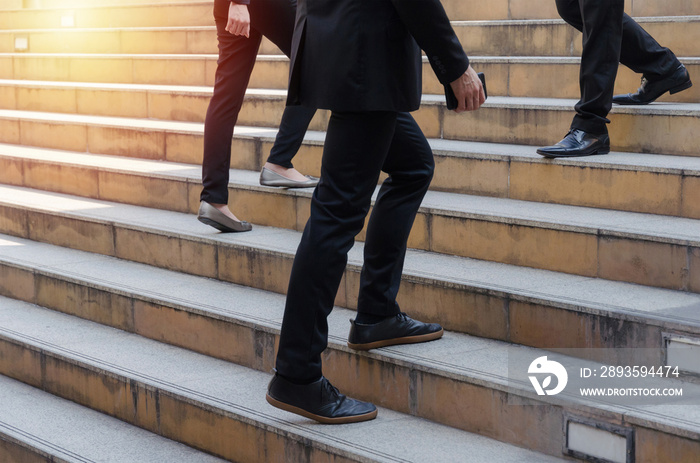 group of young business people team walking fast up and down stairs going to work time at morning in