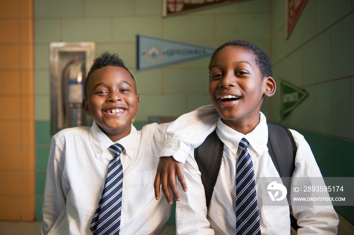 Portrait of smiling students standing in school