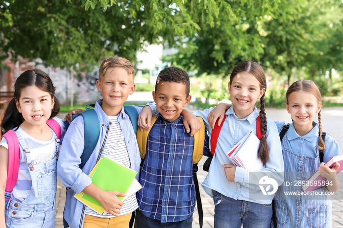 Group of cute little pupils outdoors