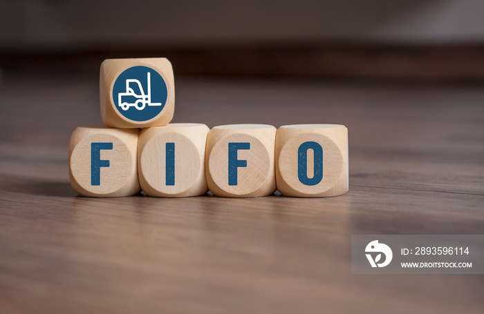 Cubes and dice with LIFO and FIFO accounting on wooden background