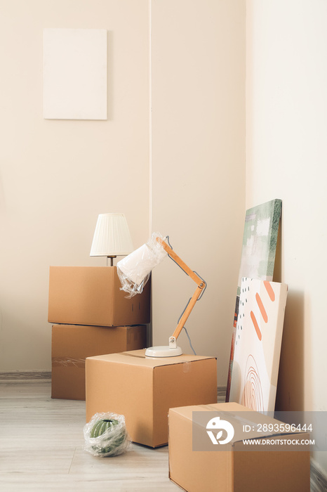 Cardboard boxes with belongings in new flat on moving day