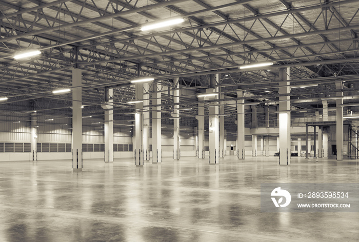 Concrete floor inside industrial building. Use as large factory, warehouse, storehouse, hangar or pl