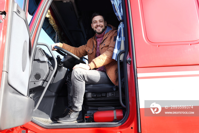 Driver in cabin of big modern truck