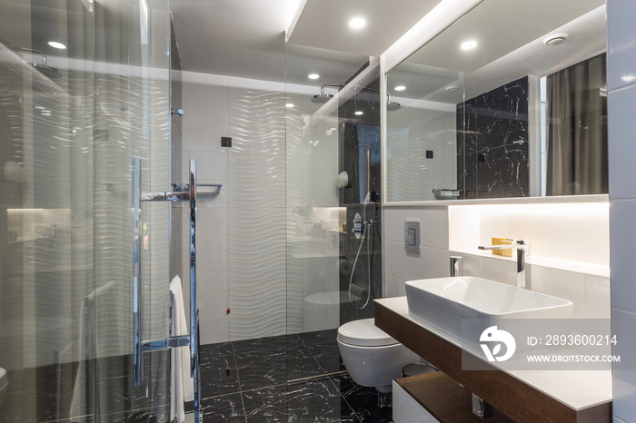 Interior of a luxury hotel bathroom with glass shower cabin