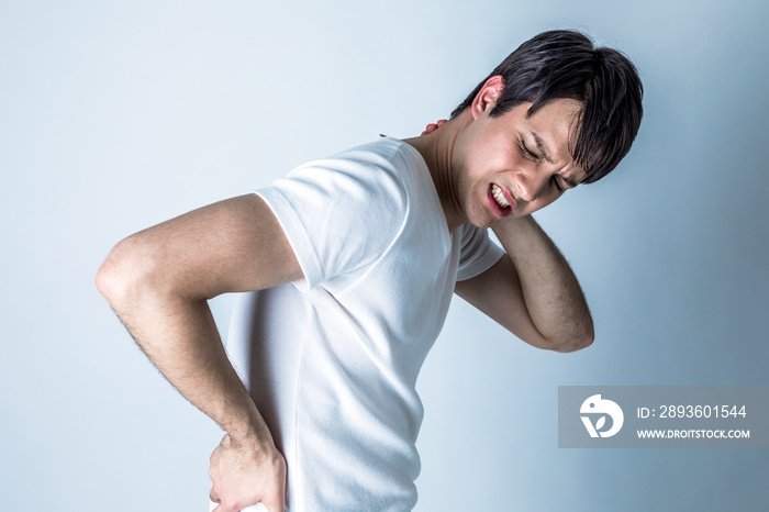 young man having a pain in his neck and low back