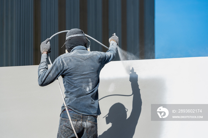 Airless Spray Painting, Worker painting on steel wall surface by airless spray gun for protection ru
