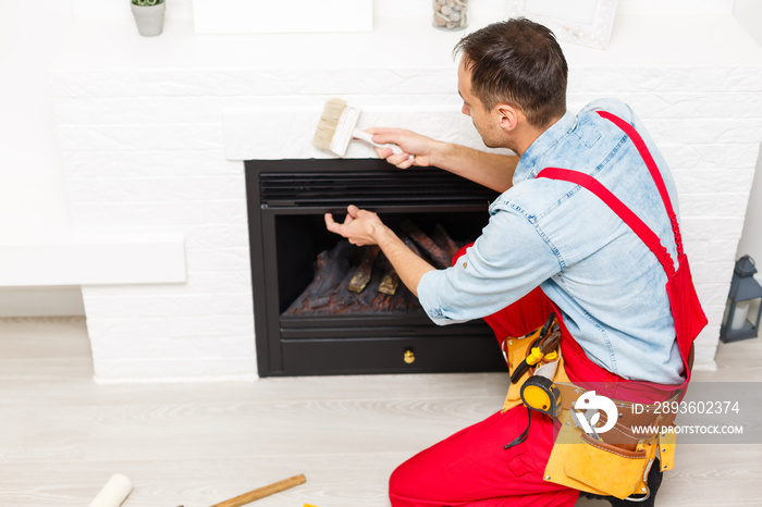 The process of installing the tile on the surface of the fireplace in the house