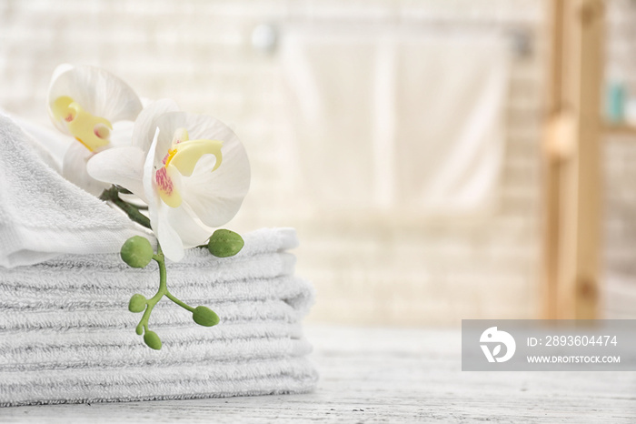 Towels with flowers on light table