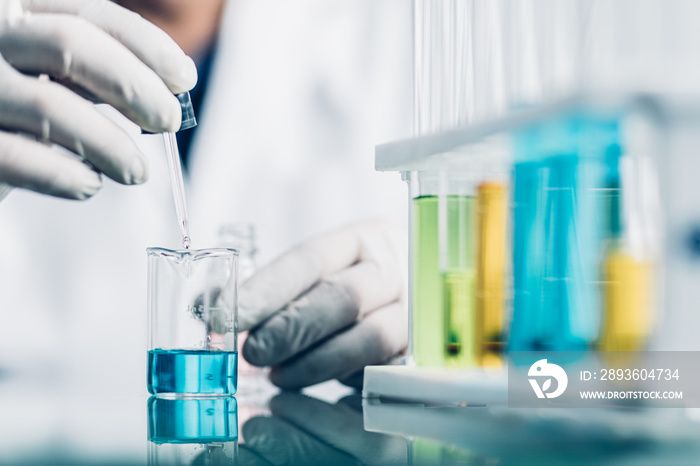 Hand of Biochemical research scientist working with science laboratory test tubes for coronavirus va