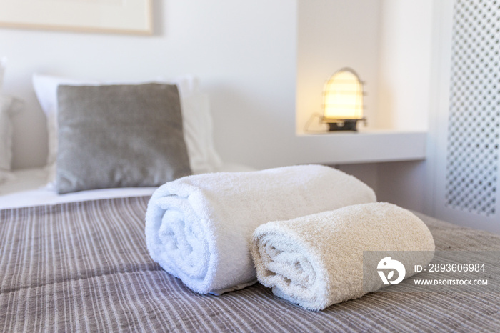 Towels for body and for hands on the bed.