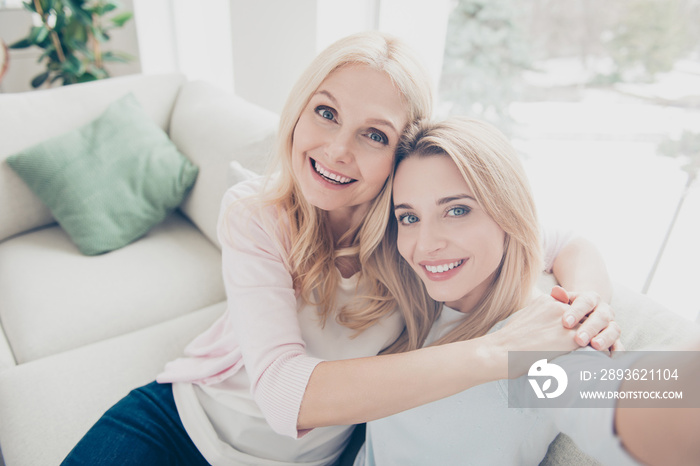 Self portrait of pretty charming attractive mother and daughter bonding shooting selfie on front cam