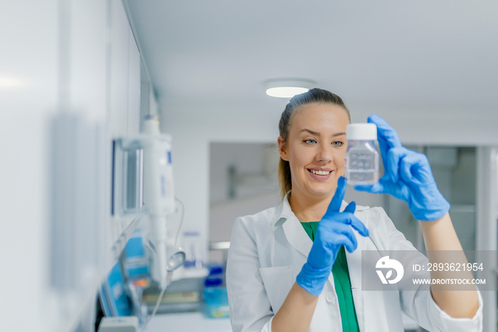 Portrait of beautiful blond woman working in modern laboratory