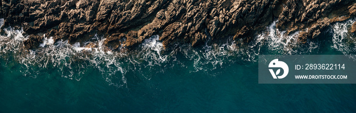 Aerial view of crashing waves on rocks, landscape overlooking nature and beautiful tropical sea over