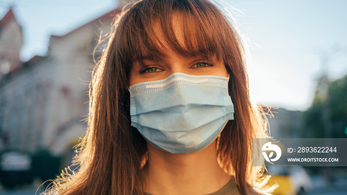 Close-up portrait young beautiful woman in medical mask