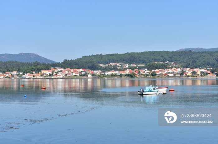 Coastal village with blue sky and water reflections. Noia or Noya, Rias Baixas, Coruña, Galicia, Spa