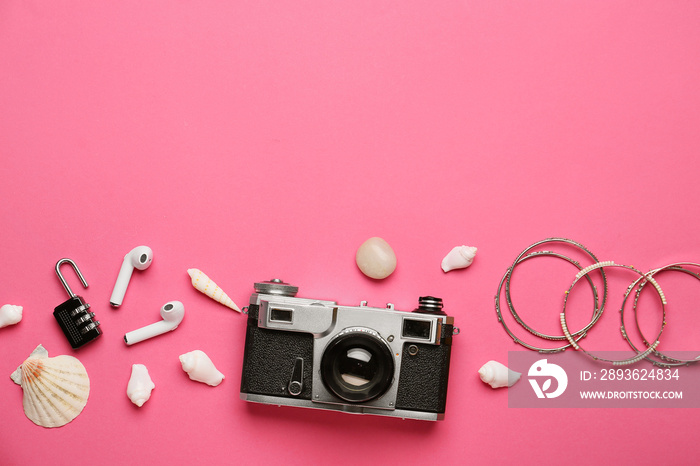 Composition with photo camera, earphones, female accessories and seashells on color background