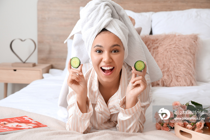 Morning of beautiful young African-American woman taking care of her skin at home