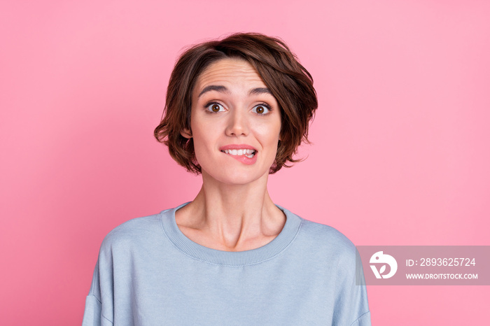 Photo of impressed millennial bob hairdo lady bite mouth wear blue sweatshirt isolated on pink color