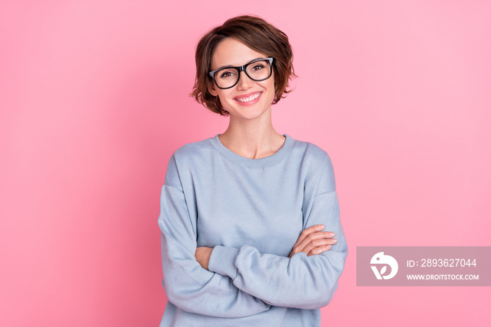 Portrait of attractive cheerful girl folded arms wearing cozy sweatshirt isolated over pink pastel c