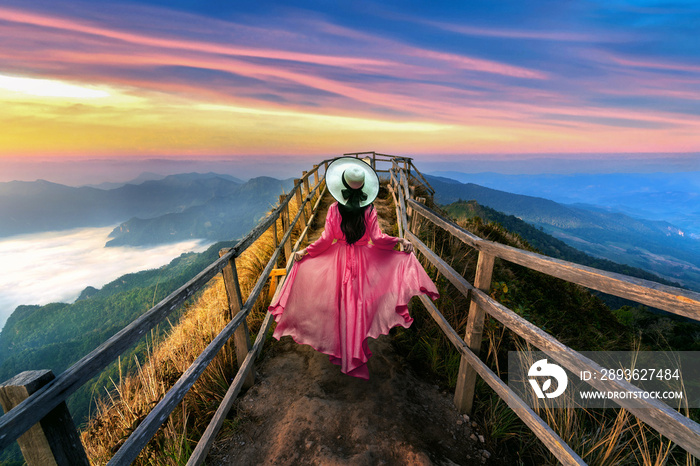 Beautiful girl running on Phu chi dao mountain at sunrise in Chiang Rai province, Thailand.