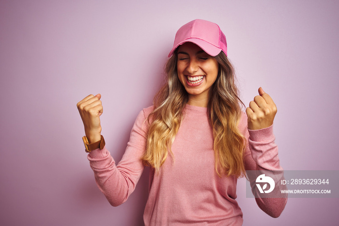 Young beautiful woman wearing cap over pink isolated background very happy and excited doing winner 