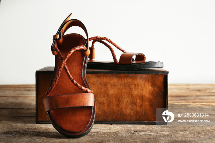 New leather sandals and gift box on the table