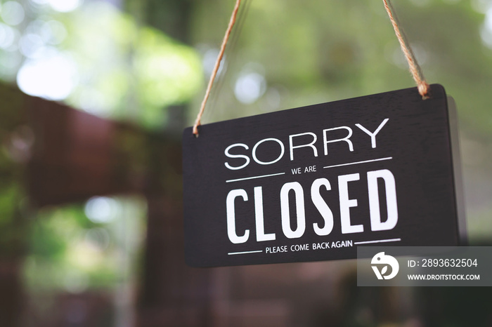 sorry closed sign on shop door. Text on cafe front or restaurant hang on door at entrance. vintage t