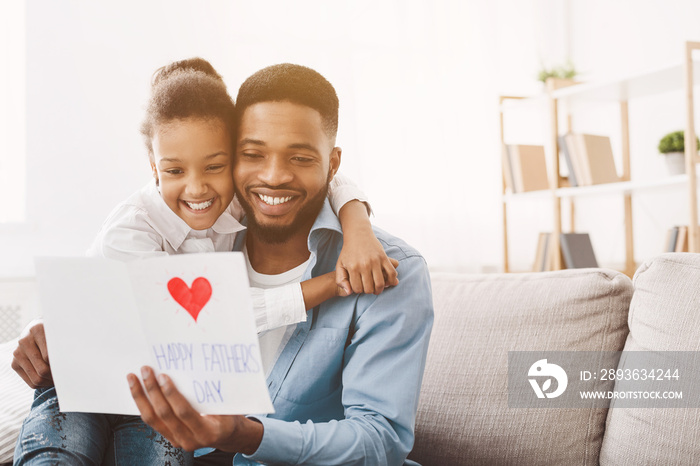 Happy fathers day. Daughter congratulating dad at home