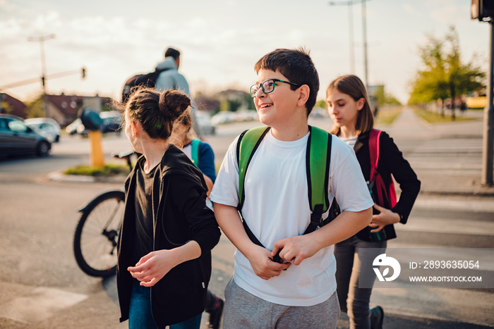 Group of school children crossing road