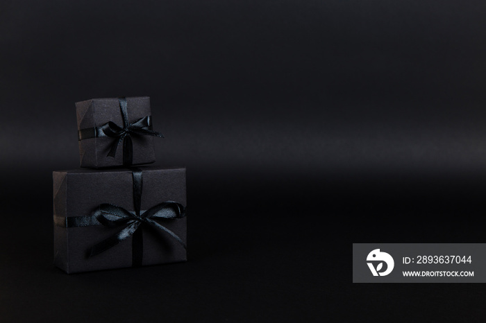 Black gift paper black background. Dark concept, sales. Copy space.