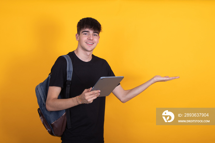 student with backpack and digital tablet isolated on background pointing