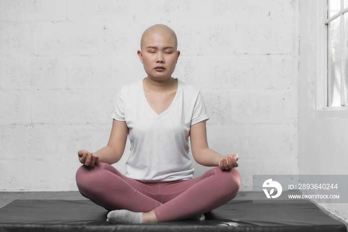 Happy Young adult female cancer patient practicing yoga. Active lifestyle