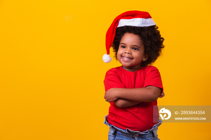 Little afro girl in red t-shirt and Santa hat dressed for christmas. Christmas and New Year campaign