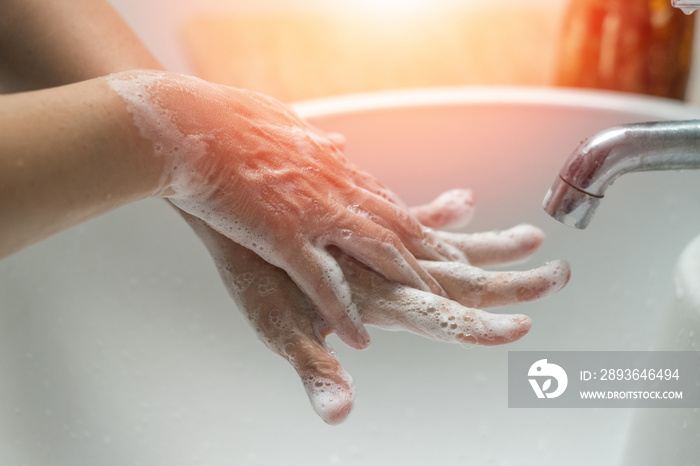 Prevent coronavirus or COVID-19 concept. Handwashing of hand wash with bubble soap at sink.