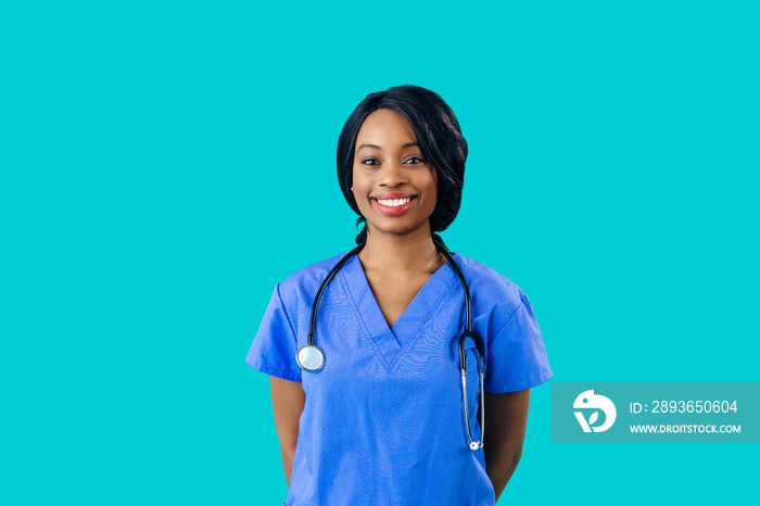 Portrait of a smiling female doctor or nurse wearing blue scrubs uniform and stethoscope and looking