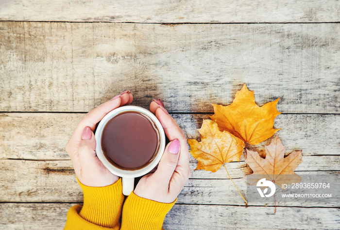 A cup of tea and a cozy autumn background. Selective focus.