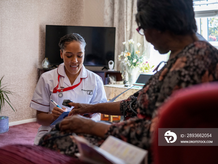 Nurse�taking care of elderly woman, measuring oxygen saturation