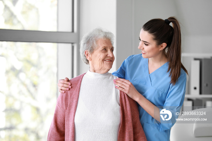 Medical worker with senior woman in nursing home