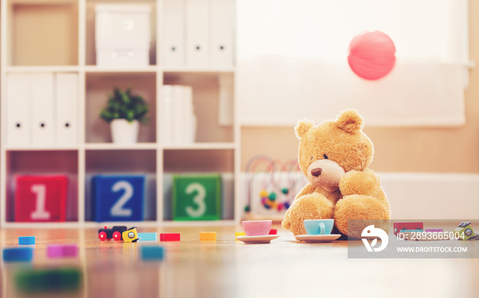 Teddy bear surrounded by toys