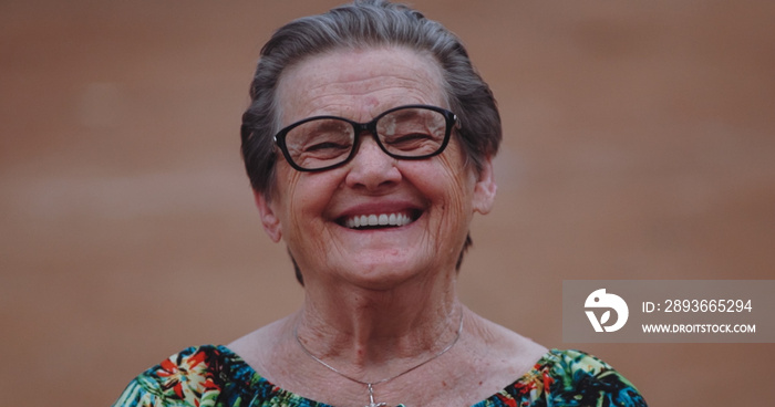 Smiling Latin elderly woman looking at camera