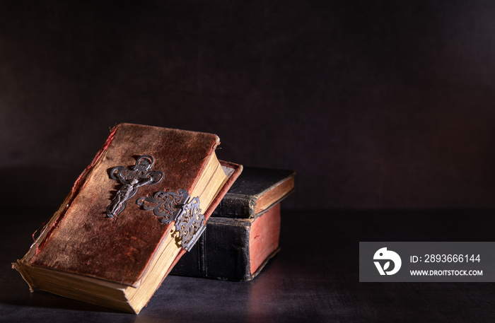 old bible on a table with candle light