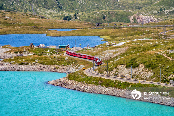 Bernina Express at the White Lake in Ospizio Bernina, Engadin, Switzerland