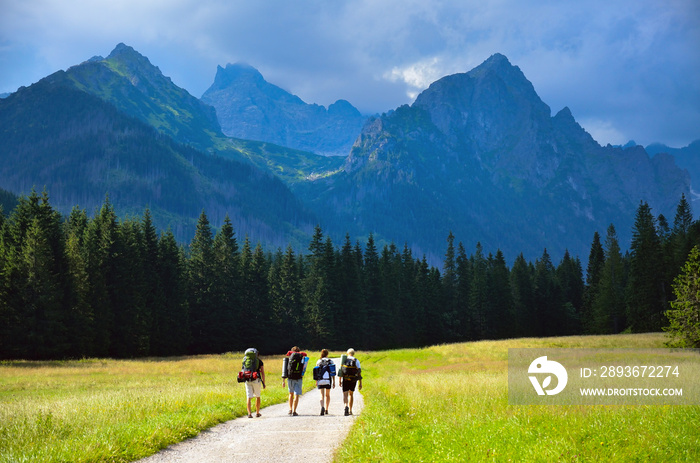 Friend hiking tohether in nature, big mountains in background. High Tatras, Slovakia