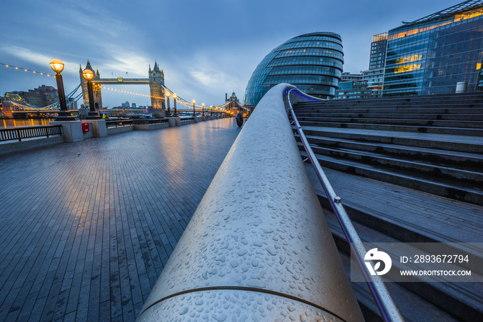 London, England - Tower Bridge and office buildings on a rainy day at blue hour