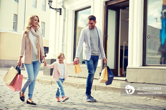 happy family with child and shopping bags in city