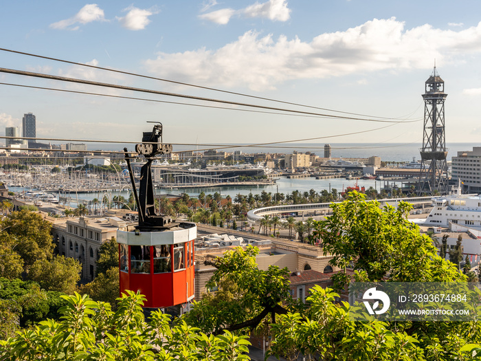 historic red cable car cabin with harbor and panorama of Barcelona city, spain