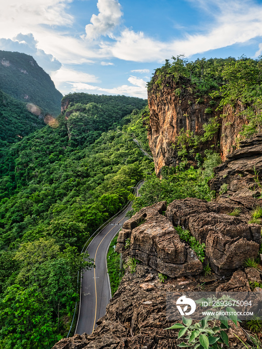 Winding roads and rocky cliffs in the green forest