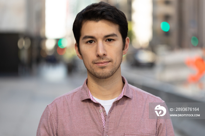 Young man in city serious face portrait